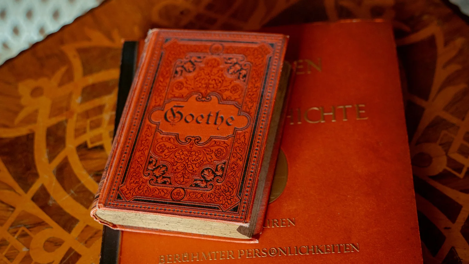 Old German-language Goethe books on an inlaid wooden table